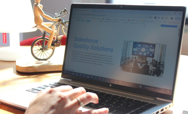 A person using a laptop to review the Nekst IT website, representing Salesforce quality assurance and seamless system integration.